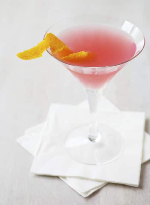 A cosmopolitan cocktail garnished and ready to serve