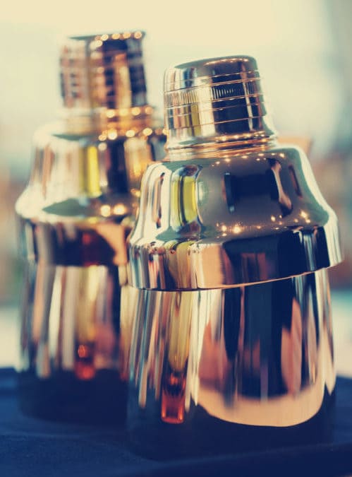 Cocktail shakers and glassware set up for a party