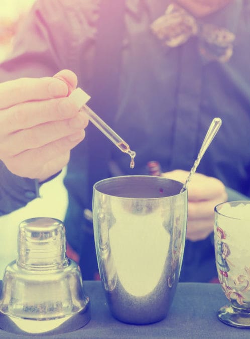 A mixologist preparing an elaborate cocktail